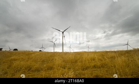Wind turbines in agricultural land. Natural energy sources. Environmentally clean electricity generation. Stock Photo