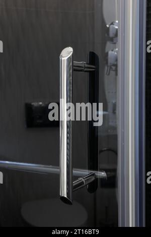Chrome handle close-up on a glass shower door Stock Photo