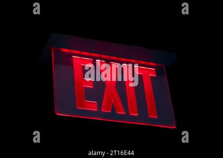 Exit sign with red letters centered on black background Stock Photo