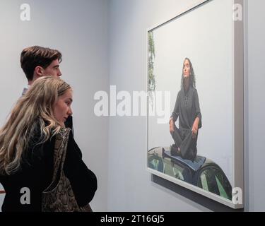 London, UK. 11th Oct, 2023. Visitors to the White Cube Gallery booth look at Jeff Wall's 'Sunseeker' (2021). Frieze London, one of the most influential contemporary art fairs, opens its doors for the first preview day today. The 2023 edition marks the 20th anniversary of Frieze London. It runs 11-15 October in Regent's Park. Credit: Imageplotter/Alamy Live News Stock Photo