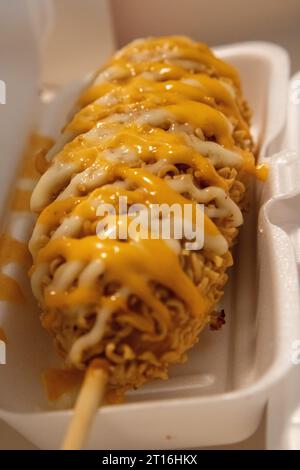 Japanese Ramen Corndog drizzled with sauce Stock Photo