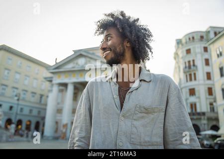 Portrait of a smiling and confident young African man looking around Stock Photo