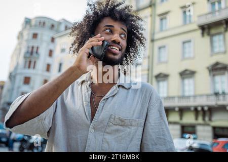 Portrait of a young attractive east African man making a phone call, photo with copy space Stock Photo