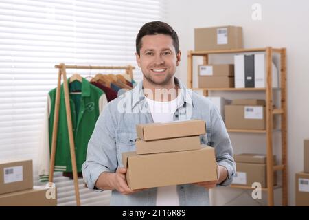 Seller with parcels in office. Online store Stock Photo