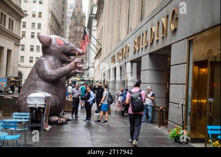 Giant inflatable rat in front of Trump Building Manhattan NY side view Stock Photo