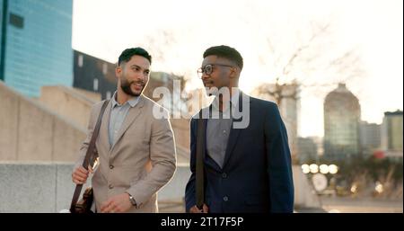 Businessmen, morning sunrise and walking to work while talking, strategy idea and business investment. Discussion, city buildings and colleagues Stock Photo