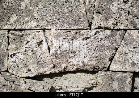 Gray-colored porous stone wall fragment Stock Photo
