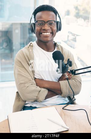 Portrait, podcast and black man with a notebook, microphone and smile ...