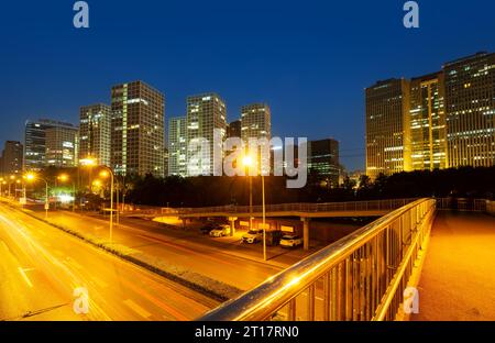 Light trails on the street at Beijing Central Business district at night in Beijing ,China. Stock Photo