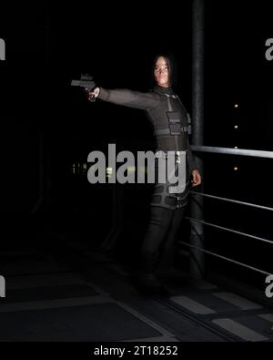Male Asian Assassin in A Dark City Street Stock Photo