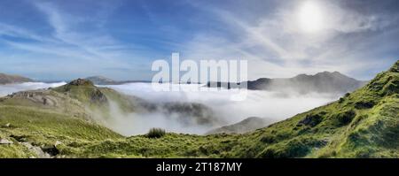 Misty panoramic view from Grib Goch in the Snowdonia National Park looking East towards Pen y Pass on a sunny day. Wales. Stock Photo