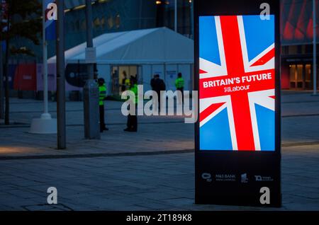 Labour Delegates early in the morning at the Liverpool Arena, for the Annual Labour Party Conference.  The advert reads Britains Future-Labour. Stock Photo
