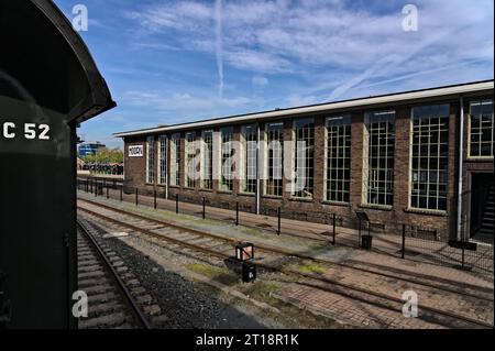 View from the railing of a train carriage, view of a side track and old train depot from the steam engine era at the station of Hoorn, the Netherlands Stock Photo