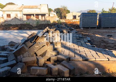 Concrete pavers being used to replace a dirt road Stock Photo