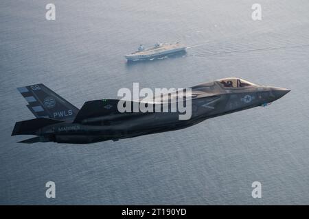 Patuxent River, United States. 11th Oct, 2023. A U.S. Marine Corps F-35B stealth fighter aircraft flown by USMC Test pilot, Maj Paul Gucwa circles to land on the flight deck of the Royal Navy Queen Elizabeth-class aircraft carrier HMS Prince of Wales during final First of Class sea trials, October 11, 2023 off the coast of Maryland, USA. Credit: Dane Wiedmann/U.S. Navy Photo/Alamy Live News Stock Photo