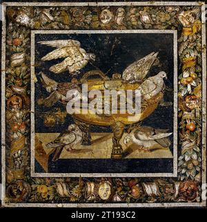 Ancient Roman floor mosaic emblema depicting the famous Doves of Pliny motif with six birds gathering around an ornate bronze water basin, originally from the House of the Mosaic Doves in Pompeii. Stock Photo