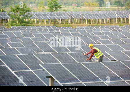 Portrait of an engineer working on solar panels at a solar powered station, Thailand Stock Photo