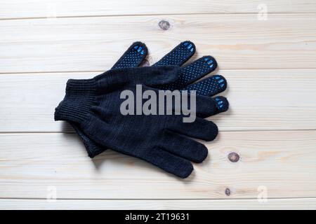 pair of black working gloves with rubber dots Stock Photo