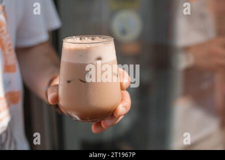 Close-up of a man's hand holding a mocha coffee Stock Photo