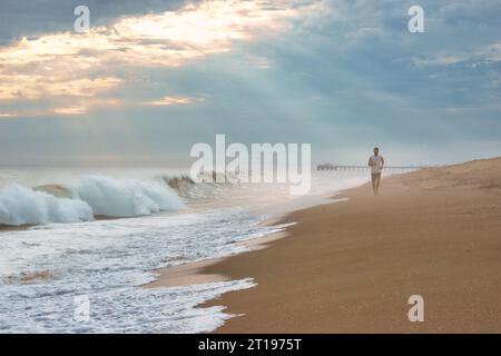 Young man jogging along the beach, California, USA Stock Photo