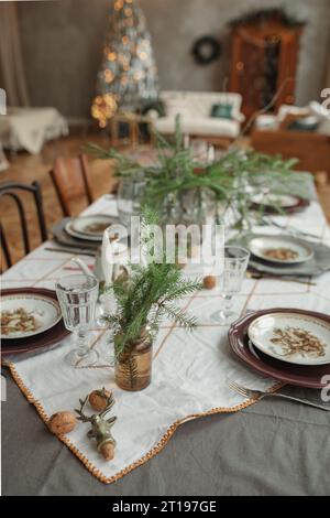Festive table setting for Christmas in an elegant open plan living and dinning room Stock Photo