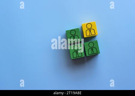 Wooden blocks with people icon on a blue background. Togetherness, diversity and inclusion, multiculturalism concept. Stock Photo