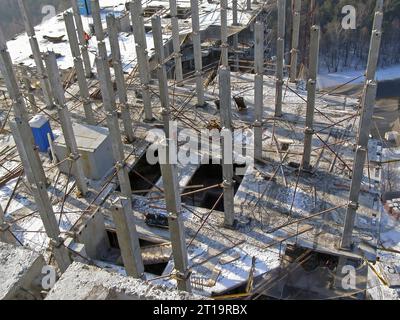 Precast reinforced concrete elements of the building, view from above. A frame made of columns and slabs on a construction site Stock Photo