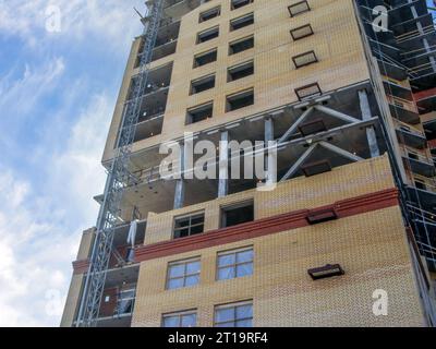 View of the high-rise building under construction. Brick walls and concrete columns Stock Photo
