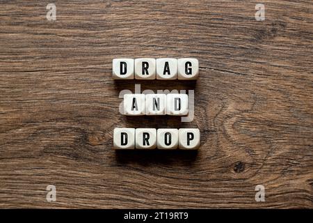 Drag and Drop - word concept on building blocks, text Stock Photo
