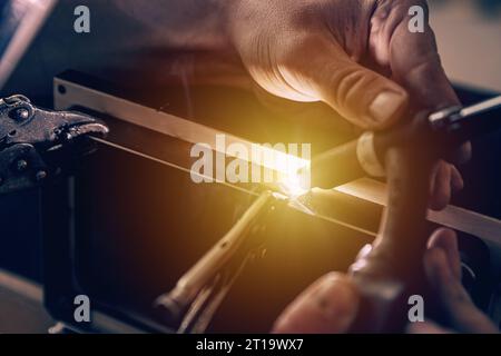 Metal welder works with a steel welder in a factory Stock Photo