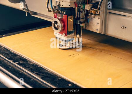 Laser cutting machine in process of cutting plywood Stock Photo