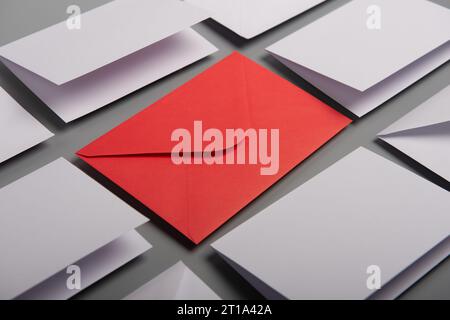 Composition with white envelopes and postcards and one red envelope on the table Stock Photo