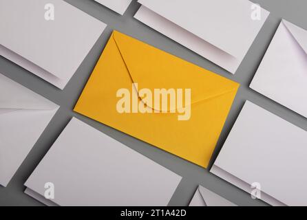 Composition with white envelopes and postcards and one yellow envelope on the table Stock Photo