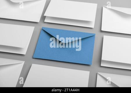 Composition with white envelopes and postcards and one blue envelope on the table Stock Photo