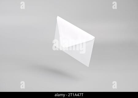 White empty envelope levitating on gray background with shadow Stock Photo
