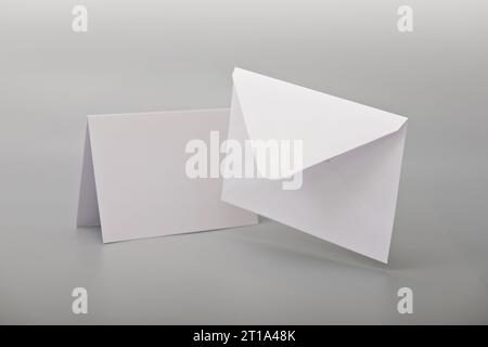 White empty envelope levitating on gray background with shadow postcard. Mockup. Stock Photo
