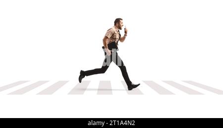 Full length profile shot of a security guard running at a pedestrian crossing and using a walkie talkie isolated on white background Stock Photo