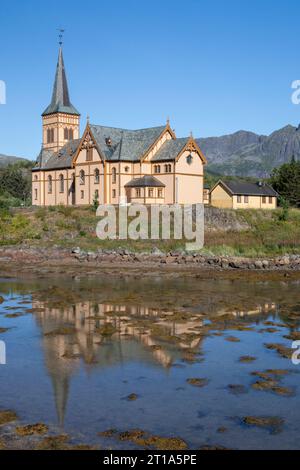 The church of Vagan, also know as the Cathedral of Lofoten, Vaganveien, Kabelvag, Lofoten Islands, Norway, reflected in the Kjerkvagen inlet Stock Photo