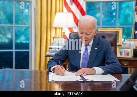 President Joe Biden signs the Hiroshi “Hershey” Miyamuria VA Clinic Bill Monday, Oct. 2, 2023, in the Oval Office of the White House.  (Official White House Photo by Adam Schultz) Stock Photo