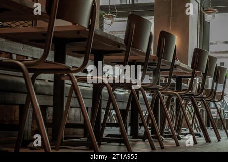 Liverpool, England - Oct 07, 2023 - Set of Wooden tables and chairs inside restaurant. Interior design, Space for text, Selective focus. Stock Photo