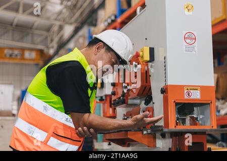 Senior male worker serious accident machine hand clamp injury in industry workplace need emergency medical help Stock Photo