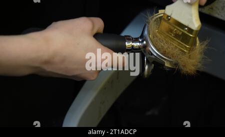 Blowing the steam tube of the coffee maker. Disinfection of dishes with steam from a coffee machine. Maintenance of cleanliness and hygiene in the bar Stock Photo