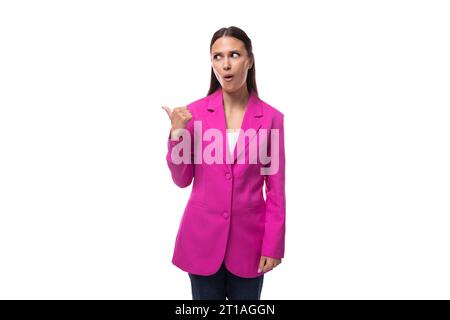 young brunette business woman dressed in a crimson chic suit on a white background with copy space Stock Photo