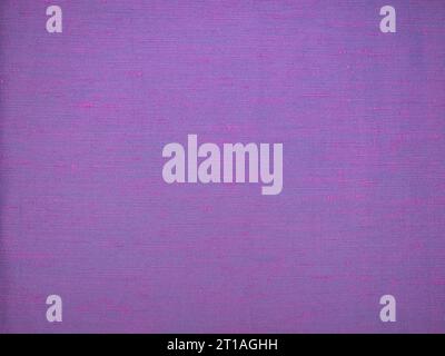Image close up showing texture of purple dupioni raw silk. Striped slubby texture. For background with text or detailed example. Stock Photo