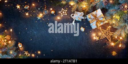 Christmas Lights With Gift Boxes Ornaments And Fir Branches On Blue Background Stock Photo