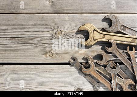 Old rusty wrenches on a wooden table Stock Photo