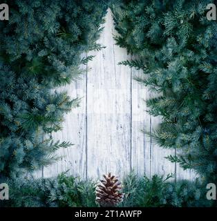 Christmas Concept - Tree Minimal Shape - Fir Branches On Wooden Snowy Background Stock Photo
