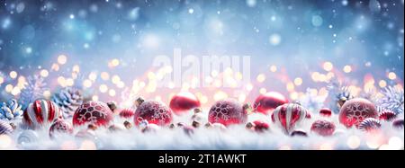 Christmas Decoration - Red Balls On White Fur With Defocused Lights and Abstract Snowy Background Stock Photo