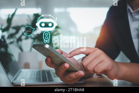 Businessman hand use show a smartphone to type live chat, ask, answer with an artificial intelligence system. chatbot. Ai assistant. Stock Photo