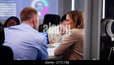 Business Team Working At Office Desk In Meeting Stock Photo